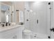 Bright bathroom featuring a glass shower, white subway tile, modern fixtures and marble vanity at 831 Bay Point Dr, Madeira Beach, FL 33708