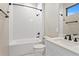 Bathroom with shower-tub combo features subway tile and a white vanity with modern fixtures at 831 Bay Point Dr, Madeira Beach, FL 33708