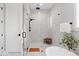 Bright bathroom featuring a glass shower, white marble tile, modern fixtures and a wooden seat at 831 Bay Point Dr, Madeira Beach, FL 33708