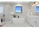 Bathroom featuring soaking tub, seamless glass shower, and marble accents at 831 Bay Point Dr, Madeira Beach, FL 33708