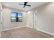 Bedroom with wood floors, ceiling fan and water view from the large black frame window at 831 Bay Point Dr, Madeira Beach, FL 33708