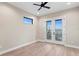 A light and airy bedroom features luxury vinyl flooring and a sliding door to the balcony with water views at 831 Bay Point Dr, Madeira Beach, FL 33708
