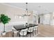 Dining area with a dark wood table, white chairs, and contemporary decor for elegant meals at 831 Bay Point Dr, Madeira Beach, FL 33708