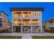 Exterior of a three-story home shows balconies, and a swimming pool in the backyard on a grass lawn at 831 Bay Point Dr, Madeira Beach, FL 33708