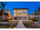 Waterfront home at twilight featuring a private dock, an in-ground pool, and a serene backyard setting at 831 Bay Point Dr, Madeira Beach, FL 33708