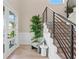 Bright foyer featuring staircase with modern railings, wood floors, chair and stylish decor at 831 Bay Point Dr, Madeira Beach, FL 33708