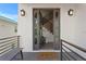 Contemporary home's inviting entry with double doors, stylish sconces and a 'Welcome' mat at 831 Bay Point Dr, Madeira Beach, FL 33708