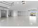 Spacious, all-white garage with epoxy flooring, two bays, and water views at 831 Bay Point Dr, Madeira Beach, FL 33708