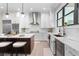 Modern kitchen with stainless appliances, subway tiles, and dark wood island at 831 Bay Point Dr, Madeira Beach, FL 33708