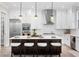 Well-lit kitchen with stainless steel appliances, white cabinets, and a center island with barstool seating at 831 Bay Point Dr, Madeira Beach, FL 33708