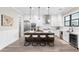 Modern kitchen featuring white cabinetry, stainless steel appliances, and a center island with seating at 831 Bay Point Dr, Madeira Beach, FL 33708