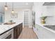 Kitchen with white cabinets, stainless steel appliances, and a center island with marble countertops at 831 Bay Point Dr, Madeira Beach, FL 33708