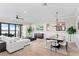 Bright and open living area with hardwood floors and sliding glass doors leading to the water at 831 Bay Point Dr, Madeira Beach, FL 33708