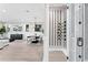 Spacious living room with modern wine storage and a large dining room with a black dining table and white chairs at 831 Bay Point Dr, Madeira Beach, FL 33708