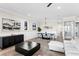 Bright living room and dining area with modern furnishings and a large abstract painting at 831 Bay Point Dr, Madeira Beach, FL 33708