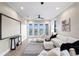 Modern living room with white furniture, a printed accent rug, and access to a balcony with water views at 831 Bay Point Dr, Madeira Beach, FL 33708