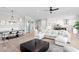 Open-concept living room and dining area featuring a large sectional sofa and modern decor at 831 Bay Point Dr, Madeira Beach, FL 33708