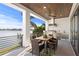 Outdoor patio featuring a full kitchen, dining area and views of the water at 831 Bay Point Dr, Madeira Beach, FL 33708