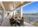 Inviting outdoor dining area with a ceiling fan and views of the beautiful waterfront at 831 Bay Point Dr, Madeira Beach, FL 33708