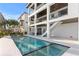 Sparkling pool and patio area with palm trees and lush landscape at 831 Bay Point Dr, Madeira Beach, FL 33708
