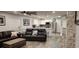 Open living room and kitchen area with modern finishes and leather sofas at 5053 N Beach Rd # 9, Englewood, FL 34223