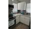 Modern kitchen with white cabinets, granite counters, and stainless steel appliances at 5053 N Beach Rd # 9, Englewood, FL 34223