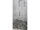 Walk-in shower with pebble stone flooring and modern glass enclosure at 5053 N Beach Rd # 9, Englewood, FL 34223