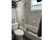 Clean bathroom with a shower/tub combo and tile surround at 5053 N Beach Rd # 9, Englewood, FL 34223
