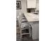 Kitchen island with four white chairs, perfect for casual dining at 5053 N Beach Rd # 9, Englewood, FL 34223