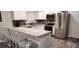 Modern kitchen with stainless steel appliances and an island with seating at 5053 N Beach Rd # 9, Englewood, FL 34223