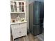 White kitchen cabinet with a stainless steel refrigerator at 5053 N Beach Rd # 9, Englewood, FL 34223