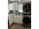 White kitchen cabinets, granite countertops, and a built-in LG washer and dryer at 5053 N Beach Rd # 9, Englewood, FL 34223