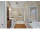 Main bathroom with marble bathtub, shower, and vanity at 2608 W Jetton Ave, Tampa, FL 33629