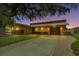 Evening view of single-story home with attached garage and brick paver driveway at 429 Flamingo Dr, Apollo Beach, FL 33572
