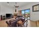 Living room features a fireplace, leather furniture, and access to a patio overlooking the water at 429 Flamingo Dr, Apollo Beach, FL 33572
