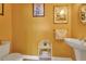 Small powder room with pedestal sink and wicker shelf at 429 Flamingo Dr, Apollo Beach, FL 33572