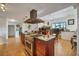Open kitchen features a large island, stainless steel appliances, and views to the living room at 429 Flamingo Dr, Apollo Beach, FL 33572