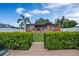 Charming backyard with lush landscaping and wooden walkway at 429 Flamingo Dr, Apollo Beach, FL 33572