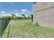 Large backyard surrounded by a black metal fence; perfect for entertaining, pets, or relaxation at 228 Star Shell Dr, Apollo Beach, FL 33572
