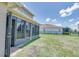 Screened in porch with a view of the well manicured lawn in the home's backyard at 228 Star Shell Dr, Apollo Beach, FL 33572