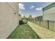 Home exterior shows fenced backyard, stucco wall, and side yard with a green lawn at 228 Star Shell Dr, Apollo Beach, FL 33572