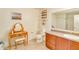 Bathroom featuring a vanity area, toilet, storage shelves and a large mirror at 228 Star Shell Dr, Apollo Beach, FL 33572