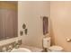 This bathroom includes neutral walls, toilet, towel rack, and sink with decor at 228 Star Shell Dr, Apollo Beach, FL 33572