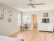 Bedroom with hardwood floors, ceiling fan, plantation shutters and a bright color scheme at 228 Star Shell Dr, Apollo Beach, FL 33572