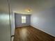 This bedroom features hardwood floors and natural light from the window at 228 Star Shell Dr, Apollo Beach, FL 33572
