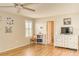 Bedroom with hardwood floors, ceiling fan, plantation shutters and a bright color scheme at 228 Star Shell Dr, Apollo Beach, FL 33572