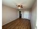 This bedroom features hardwood floors, tan walls and a ceiling fan at 228 Star Shell Dr, Apollo Beach, FL 33572