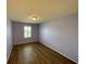 This bedroom features hardwood floors and natural light from the window at 228 Star Shell Dr, Apollo Beach, FL 33572