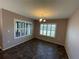 Dining room featuring large windows with modern shutters and chandelier lighting at 228 Star Shell Dr, Apollo Beach, FL 33572