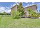 Two story home with a manicured lawn, mature trees, and a sidewalk leading to the front door at 228 Star Shell Dr, Apollo Beach, FL 33572